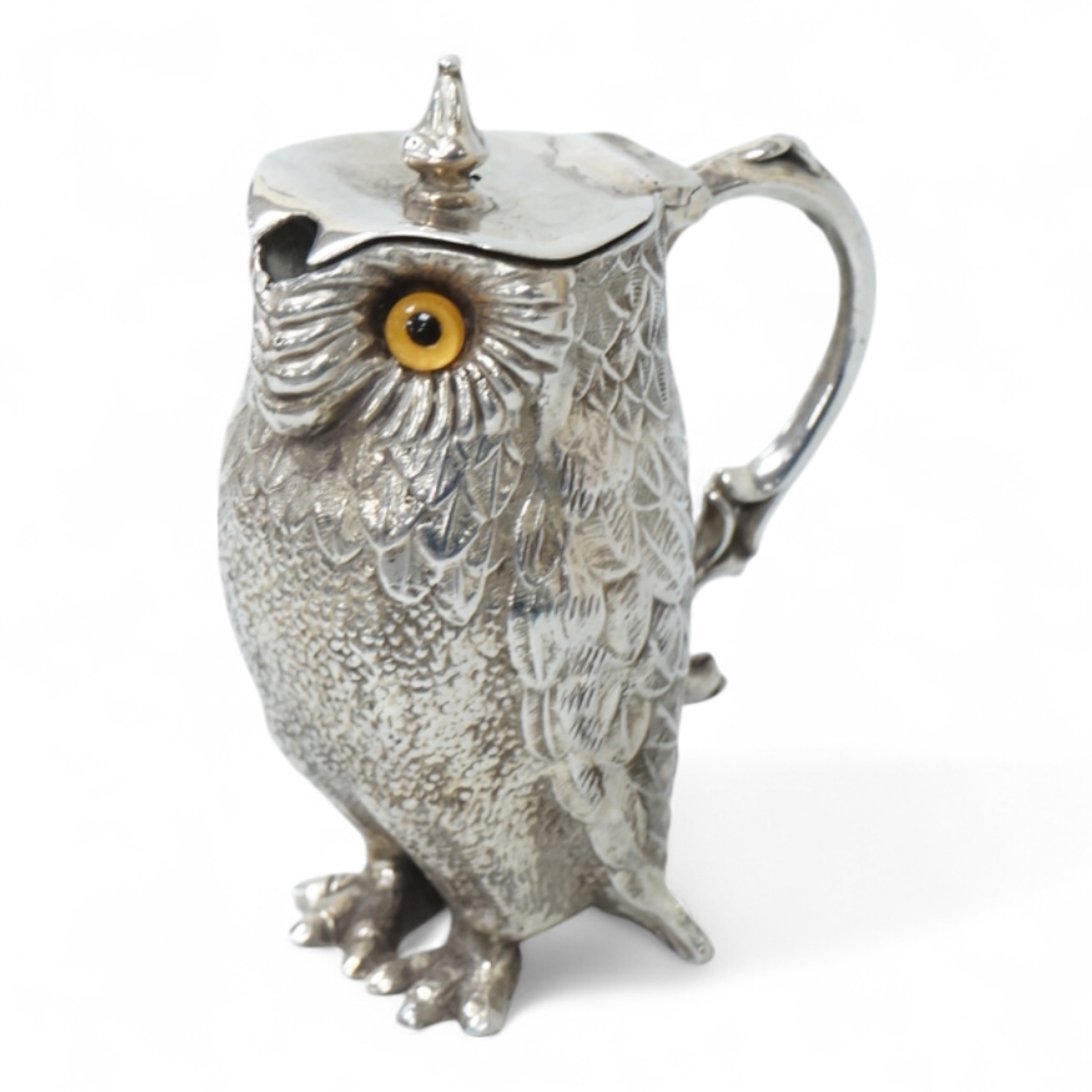 A novelty white metal single handled mustard pot, modelled as a free-standing owl, with hinged cover and textured 'feathers', unmarked, height 95mm.